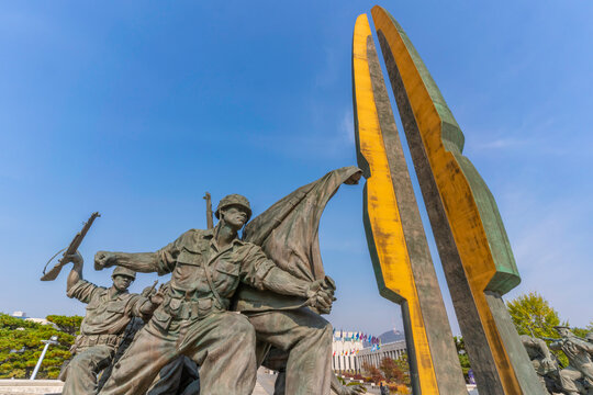 Sculptures show military figures at War Memorial of Korea under clear sky in Yongsan District, Seoul, South Korea
