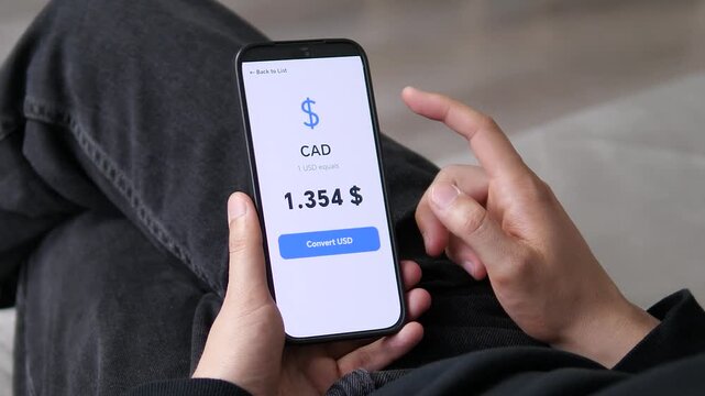 User selecting the CAD rate (1.354) from a global currency list. The screen highlights the Canadian Dollar value against the USD. Ideal for North American finance, cross-border trade, and currency