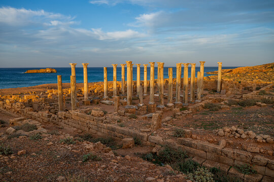 Ruins of ancient Apollonia show columns along the coast in Libya during sunset