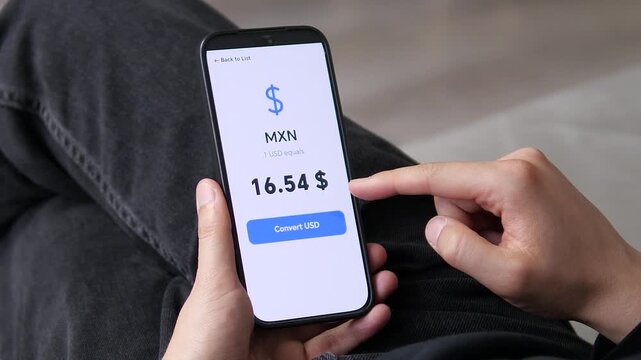 User checking the MXN to USD exchange rate at 16.54. High value indicates a favorable rate for travel. Ideal for Mexican tourism, holiday budgeting, and currency conversion stock footage.