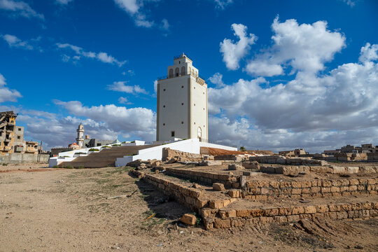 Benghazi Lighthouse stands in an open area surrounded by historical ruins in Libya