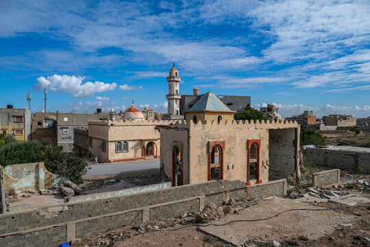 War damaged buildings near lighthouse in Benghazi depict the effects of conflict in Libya's urban landscape