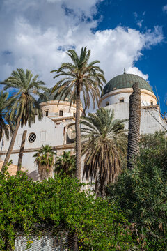 Benghazi cathedral stands among palms and blue skies in Eastern Libya while weathered walls tell stories of the past
