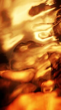 Vertical absrtract golden water macro background with gradient liquid on red orange backdrop. 3D animation wave fluid swirling backplate with copy space. Elegant seamless loop texture.