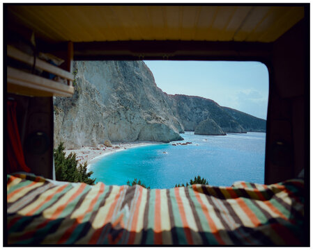 View from inside camper van looking out at beach in Greece, film 