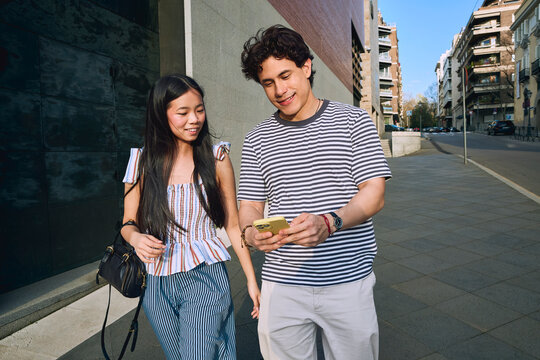 Friends checking directions on smartphone while exploring the city