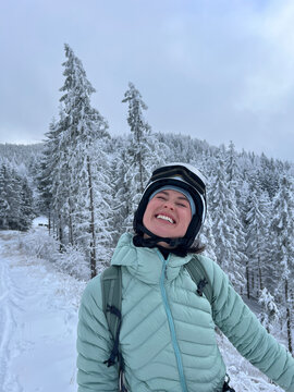 Happy woman enjoying a ski touring adventure in winter.