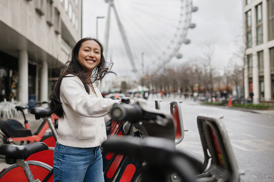 Smiling adventurer getting shared bicycle in London