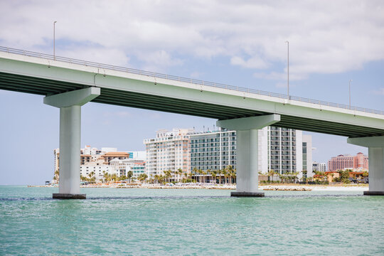 Coastal Bridge Over Turquoise Water Near Waterfront Skyline