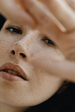 Dark Brunette Woman's Portrait with a lot of freckles