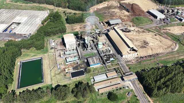 Aerial View of a Large Industrial Plant with Cooling Towers and Storage Piles