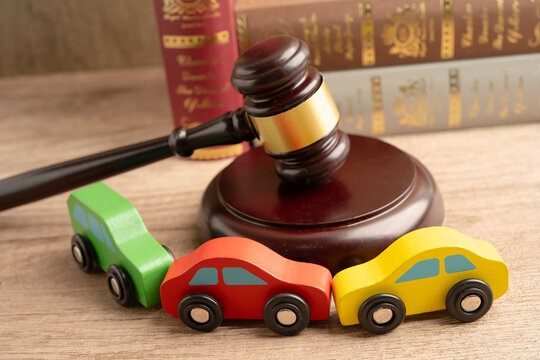 Car accident lawsuit and insurance, Judge hammer with car model.