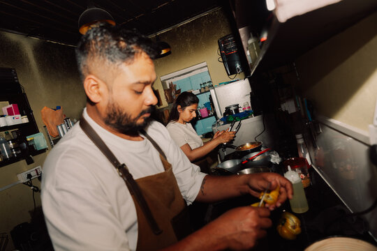 Indian Chef Couple Cooking Together in a Small Commercial Restaurant