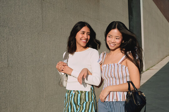 Smiling friends sharing a moment during urban exploration
