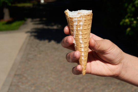 Person holding melted ice-cream