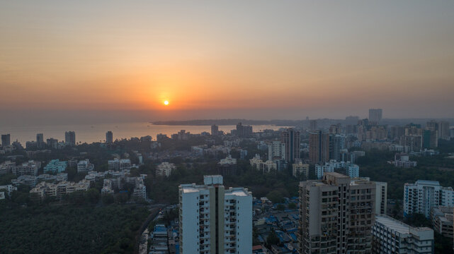 Beautiful sunset over Arabian Sea from Versova Mumbai drone view,
Urban skyline and Versova Beach during sunset in Mumbai India,
Aerial landscape of Versova coastline with evening skyline