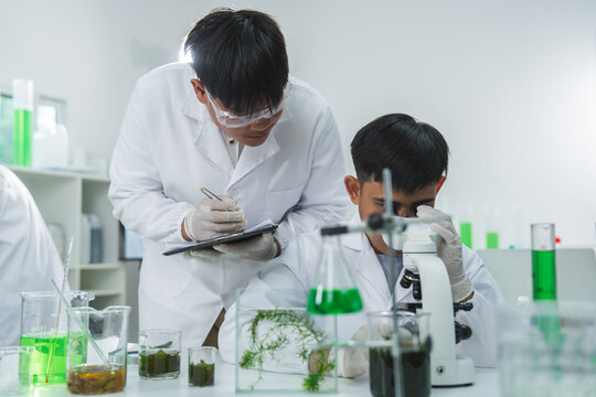 Scientist child laboratory microscope experiment chemistry lab coat safety goggle green liquid glassware study scene with plant sample and note