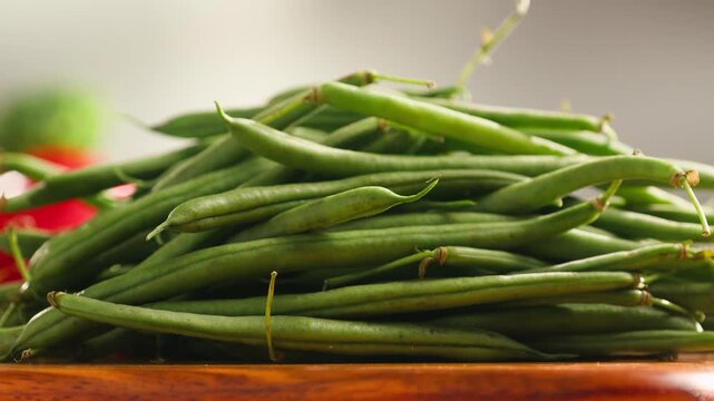 Fresh green beans and vegetables on a wooden table, spanish extra fine beans, chinese long bean. 