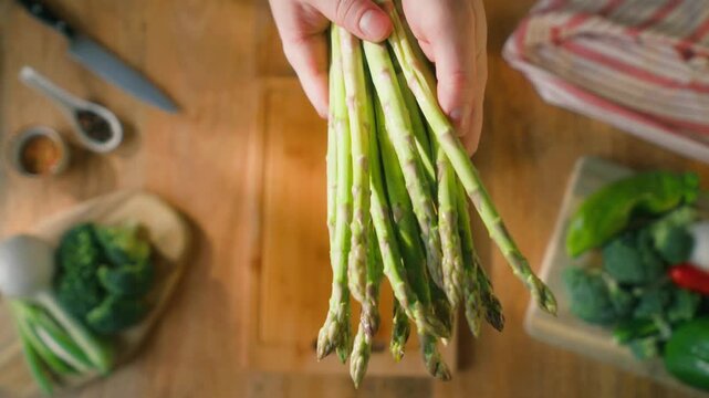 Fresh green asparagus on kitchen with broccoli and green pepper, vegan healthy food. Bunch of green asparagus close-up