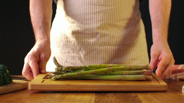 Fresh green asparagus on kitchen with broccoli and green pepper, vegan healthy food. Bunch of green asparagus close-up