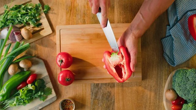 Man cut red sweet pepper, Chef hands with knife for onion, cutting and preparation with cooking for dish. Restaurant, culinary service and cook with skills for catering, business and hospitality by
