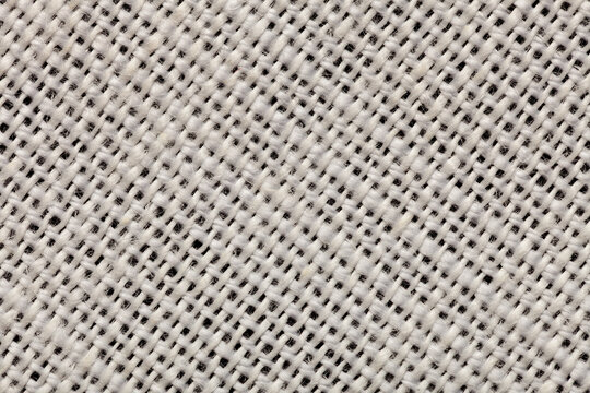 Macro close-up of a white 58% linen 42% polyester fabric blend, revealing fiber detail and woven structure for textile design projects.
