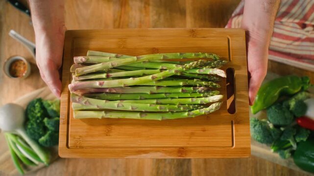 Fresh green asparagus on kitchen with broccoli and green pepper, vegan healthy food. Bunch of green asparagus close-up