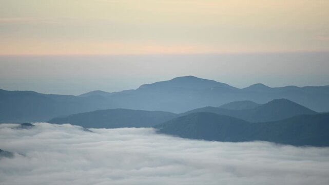Timelapse of a sea of clouds rolling over Craggy Pinnacle in North Carolina, with the Blue Ridge Mountains emerging above the morning cloud inversion