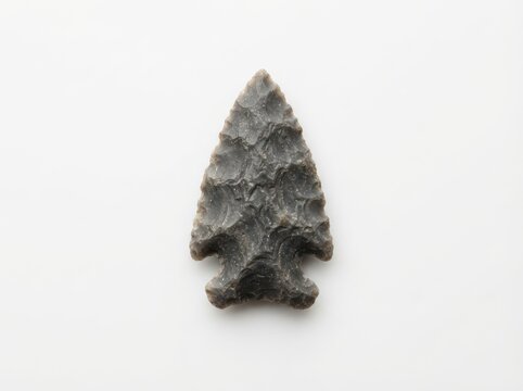 Ancient stone arrowhead isolated on white background