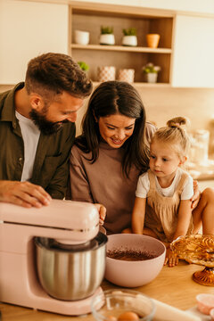 Family baking together in kitchen enjoying sweet time