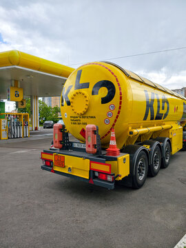 Fuel tanker truck in yellow color standing at KLO gas station for delivery process