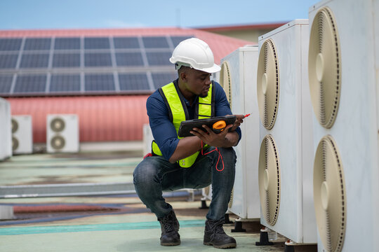 Professional engineers inspecting and checking the industrial air conditioning cooling system and HVAC units of a major facility or commercial building