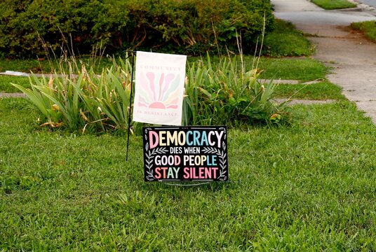 Sign says democracy dies when good people stay silent