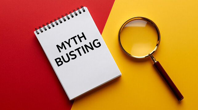 A magnifying glass rests beside a notebook labeled Myth Busting on a split red and yellow background. A concept for.