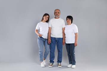 Fototapeta premium Happy family. Parents and their daughter on light grey background
