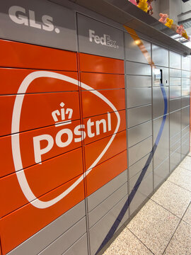 den haag, netherlands - march 18 2026: Parcel lockers show services from Postnl GLS and FedEx in a busy area with bright colors and clear markings on the unit.