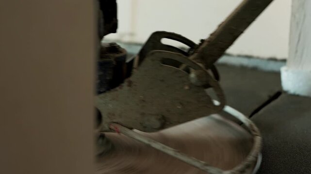 Power trowel polishing cement floor screed after installation