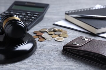 Alimony. Wallet, coins, calculator, notebook and gavel on grey table, closeup