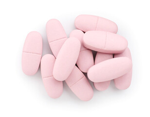 Obraz premium Pile of pink pills isolated on white, top view