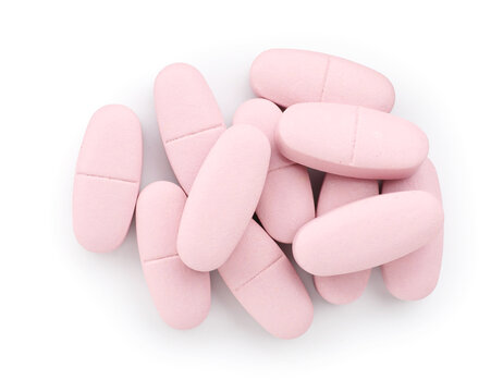 Pile of pink pills isolated on white, top view
