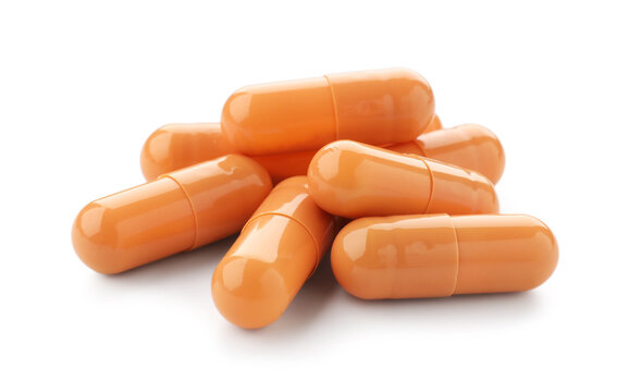 Pile of orange pills isolated on white