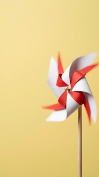 Vibrant red white paper pinwheel spinning motion blur yellow backdrop festive patriotic symbol indonesia independence day 17 agustus commercial use