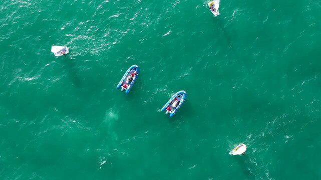Aerial view of groupes of Optimist Class sailboats before the starting of a regatta in Alicante, in the Mediterranean coast of Spain.