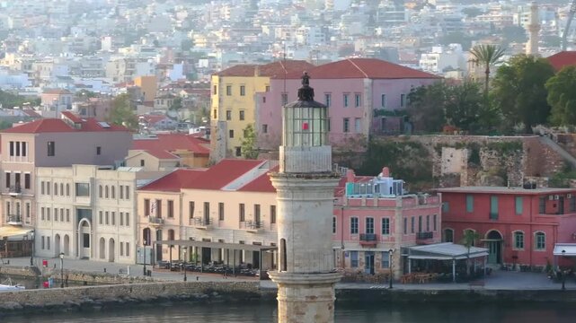  View of Chania with the amazing lighthouse, mosque, venetian shipyards, Crete, Greece.Waves crashing on lighthouse, Beautiful Greece and best scenic places - panorama
