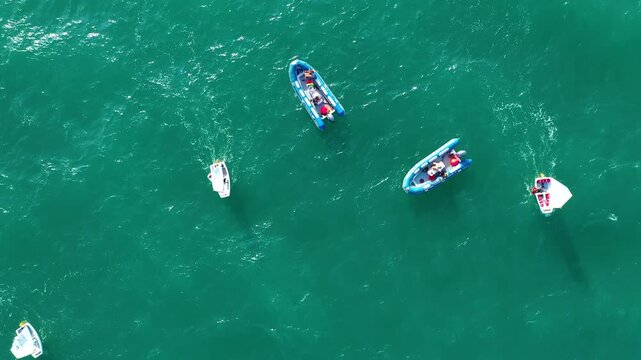 Aerial view of groupes of Optimist Class sailboats before the starting of a regatta in Alicante, in the Mediterranean coast of Spain.