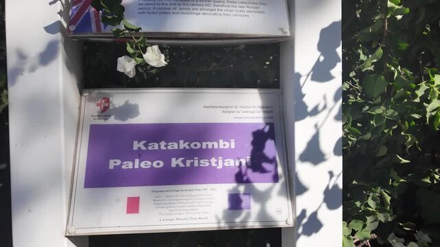 Naxxar, Salina, Malta 06.07.2026 - A bilingual information sign titled Katakombi Paleo Kristjani Paleo-Christian Catacombs explains that the site may date to the 2nd-3rd century AD, late Roman period,