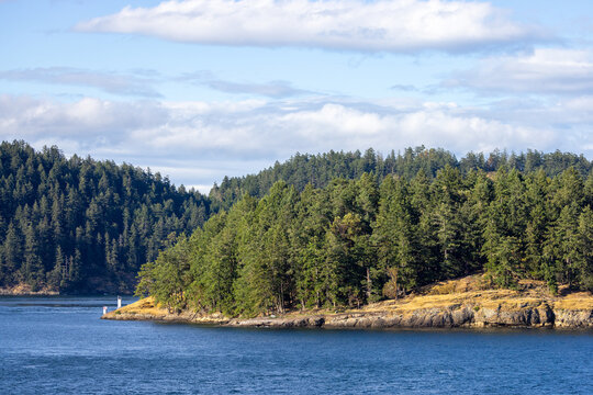 Evergreen Forested Island and Coastal Channel with Blue Water in Gulf Islands, British Columbia, Canada