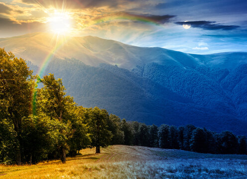 carpathian mountain landscape in summer. day meet night. primeval beech forest on the grassy hill. sun and moon over epic scenery of ukrainian highlands. pristine ecosystem of europe for wallpaper