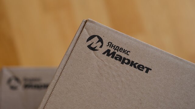 Tambov, Russian Federation - June 22, 2026 A close-up shot of a logo Yandex Market on cardboard box.