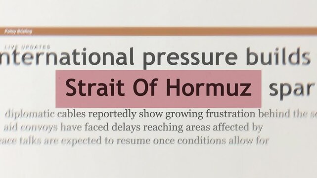 Close up set of newspaper headlines reading strait of hormuz for breaking political news regarding united states and iran trade war conflict